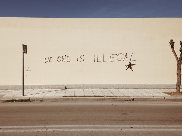 no-one is illegal written on wall