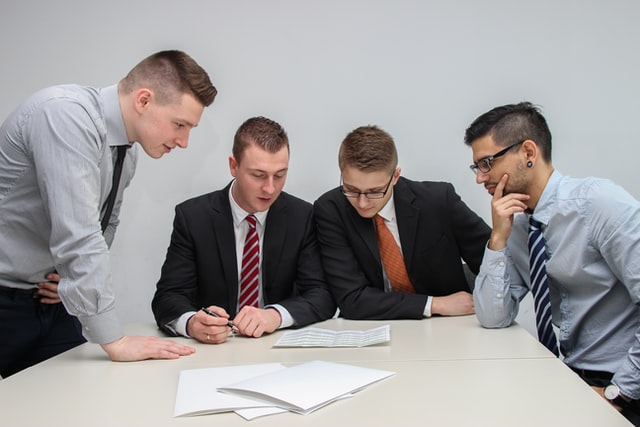 a photo of a team working together in an office